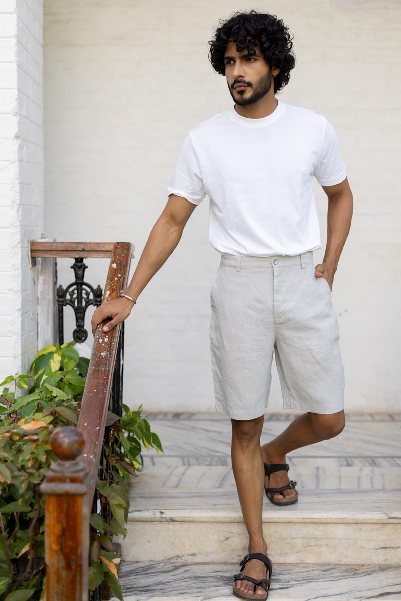 Person Classic Cream Shorts and a white shirt against a plain background