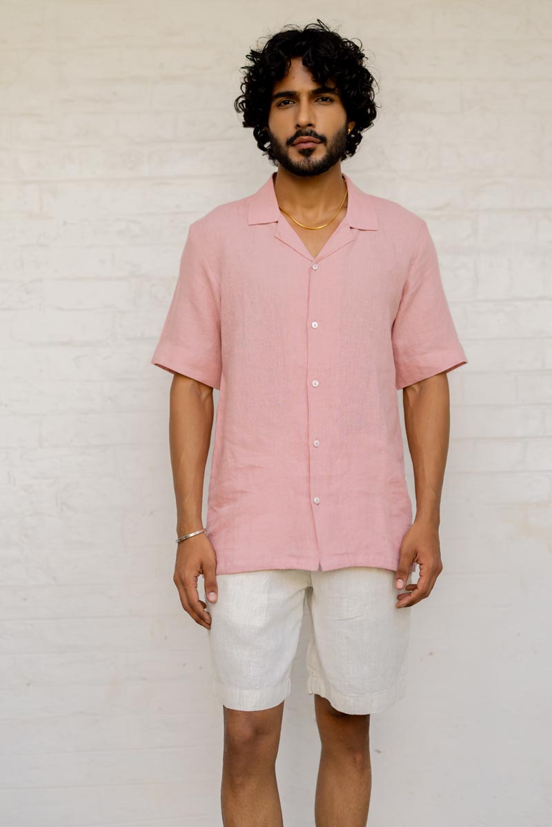 Man wearing a Cuban Collar Rose Shirt and white shorts against a light background