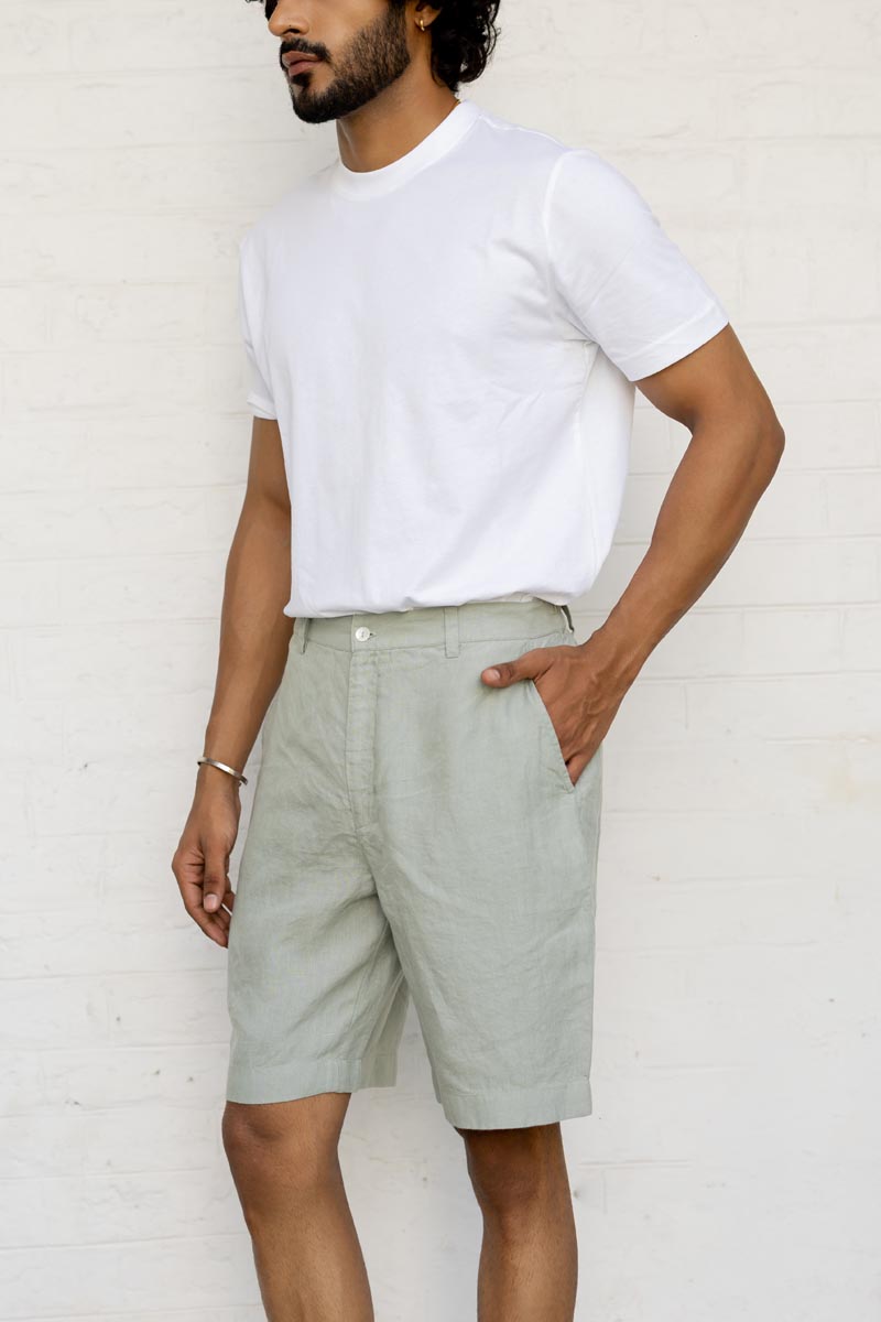 Man wearing a white t-shirt and Mint Green Shorts against a white background
