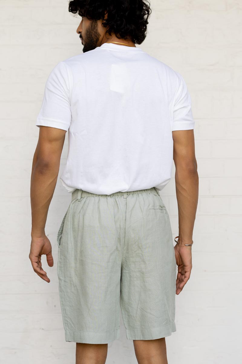 Person wearing a white t-shirt and Mint Green Shorts against a plain background