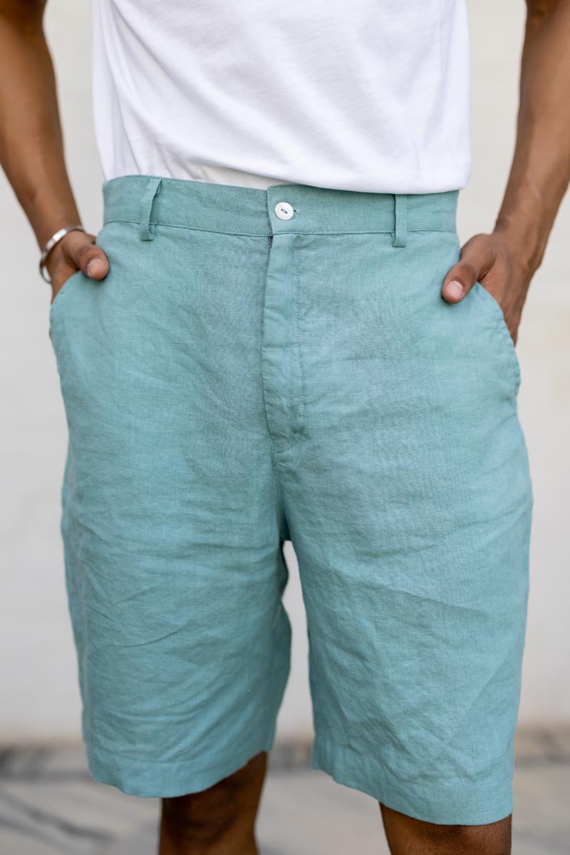 Person wearing Pine Green Shorts with a white background