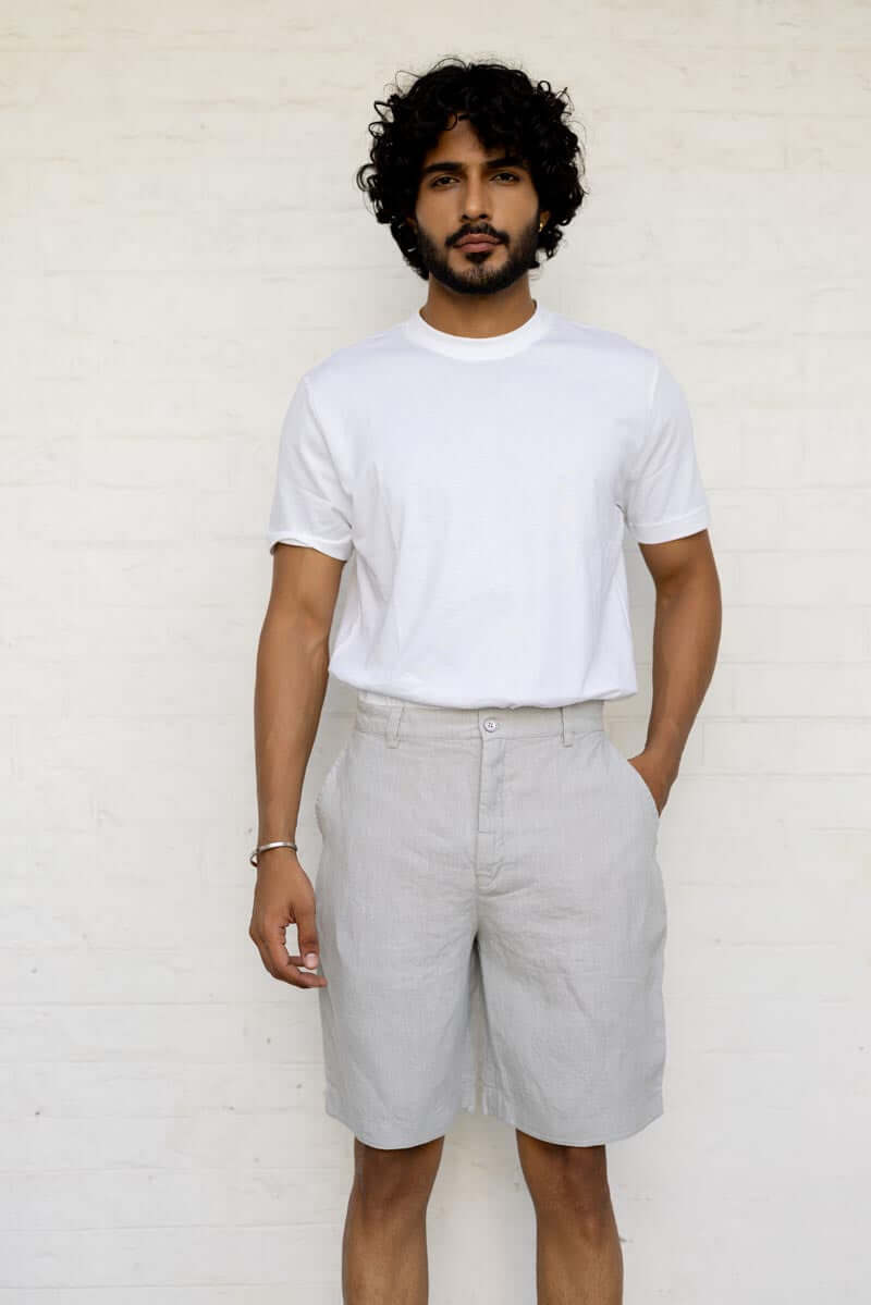 Man wearing a white t-shirt and Cloud Grey Shorts against a white background