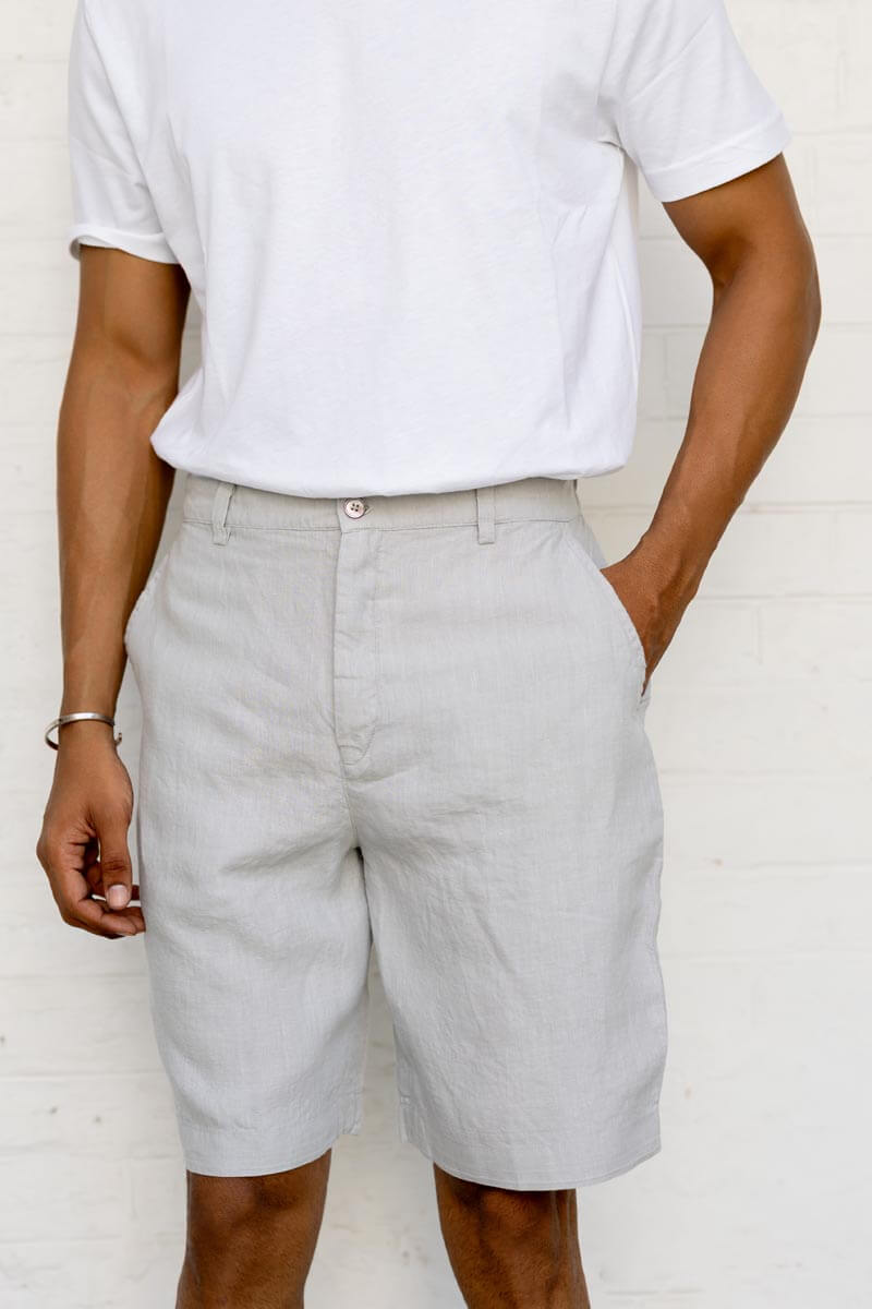 Person wearing Cloud Grey Shorts and a white t-shirt against a plain background