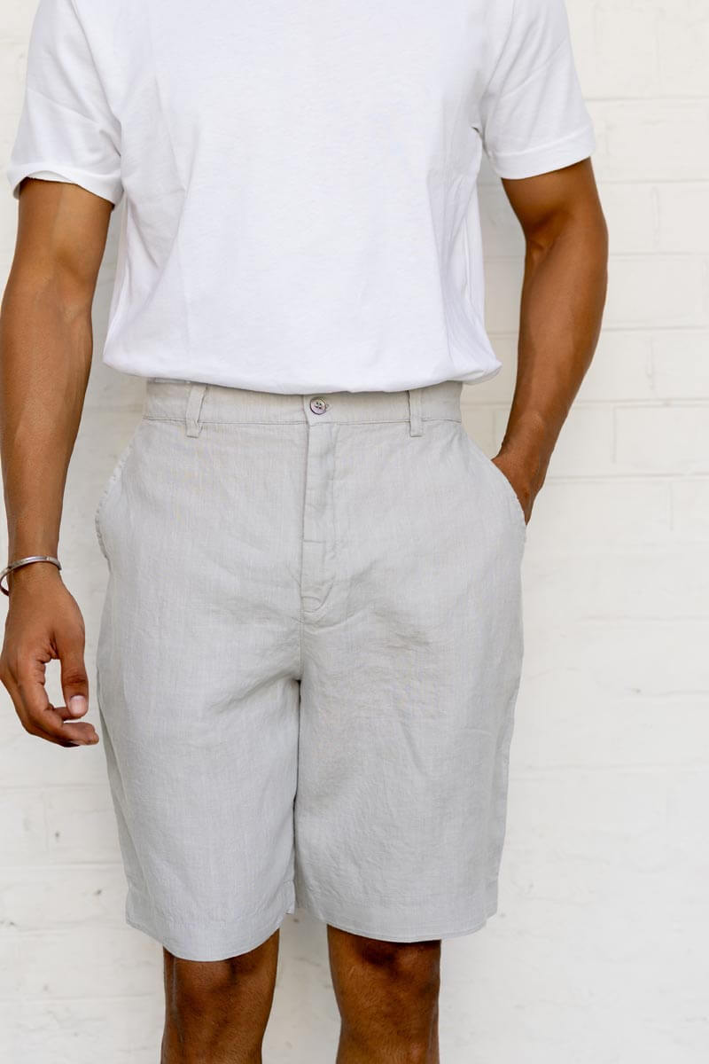 Person wearing Cloud Grey Shorts shorts and a white t-shirt against a white background
