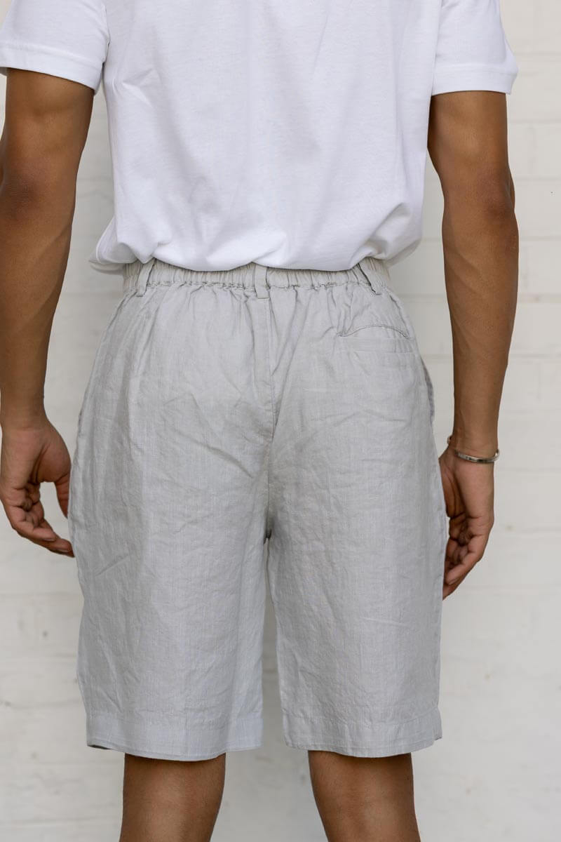 Person wearing lCloud Grey Shorts and a white shirt against a plain background