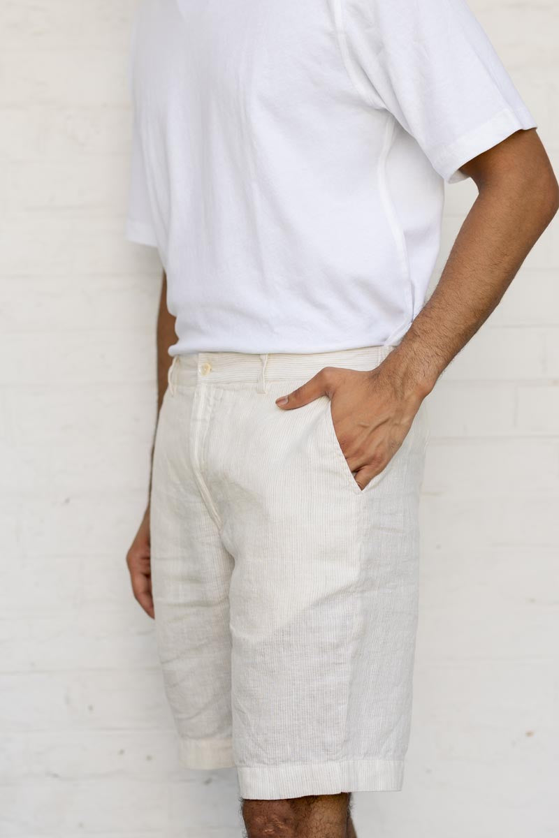 Person wearing a white t-shirt and Ivory Fine Stripe Shorts against a plain background