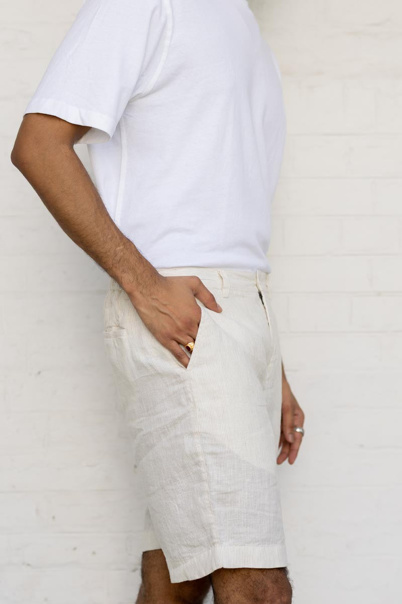 Person wearing a white t-shirt and Ivory Fine Stripe Shorts against a plain background