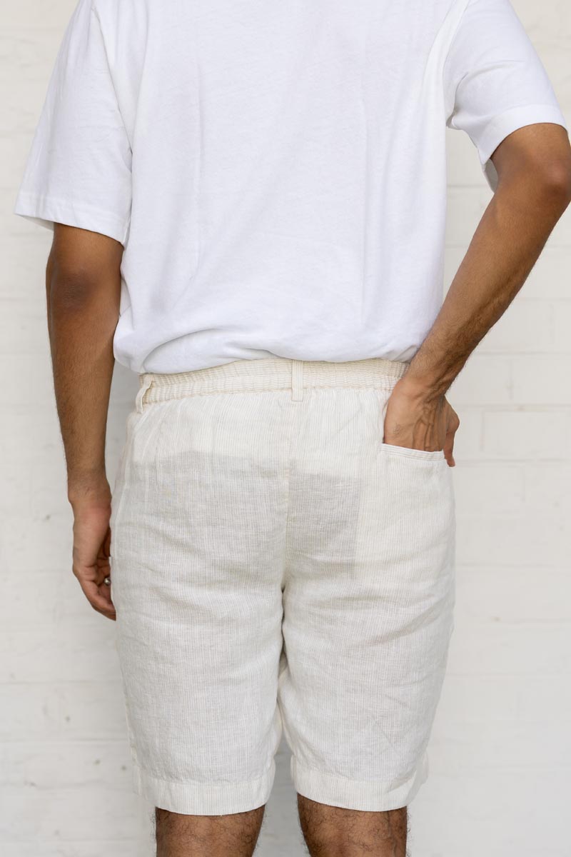Person wearing Ivory Fine Stripe Shorts and a white t-shirt against a plain background
