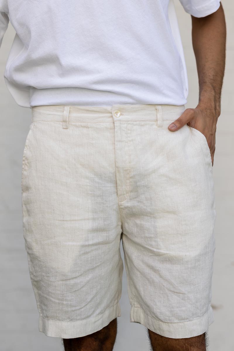 Person wearing Ivory Fine Stripe Shorts and a white shirt against a plain background