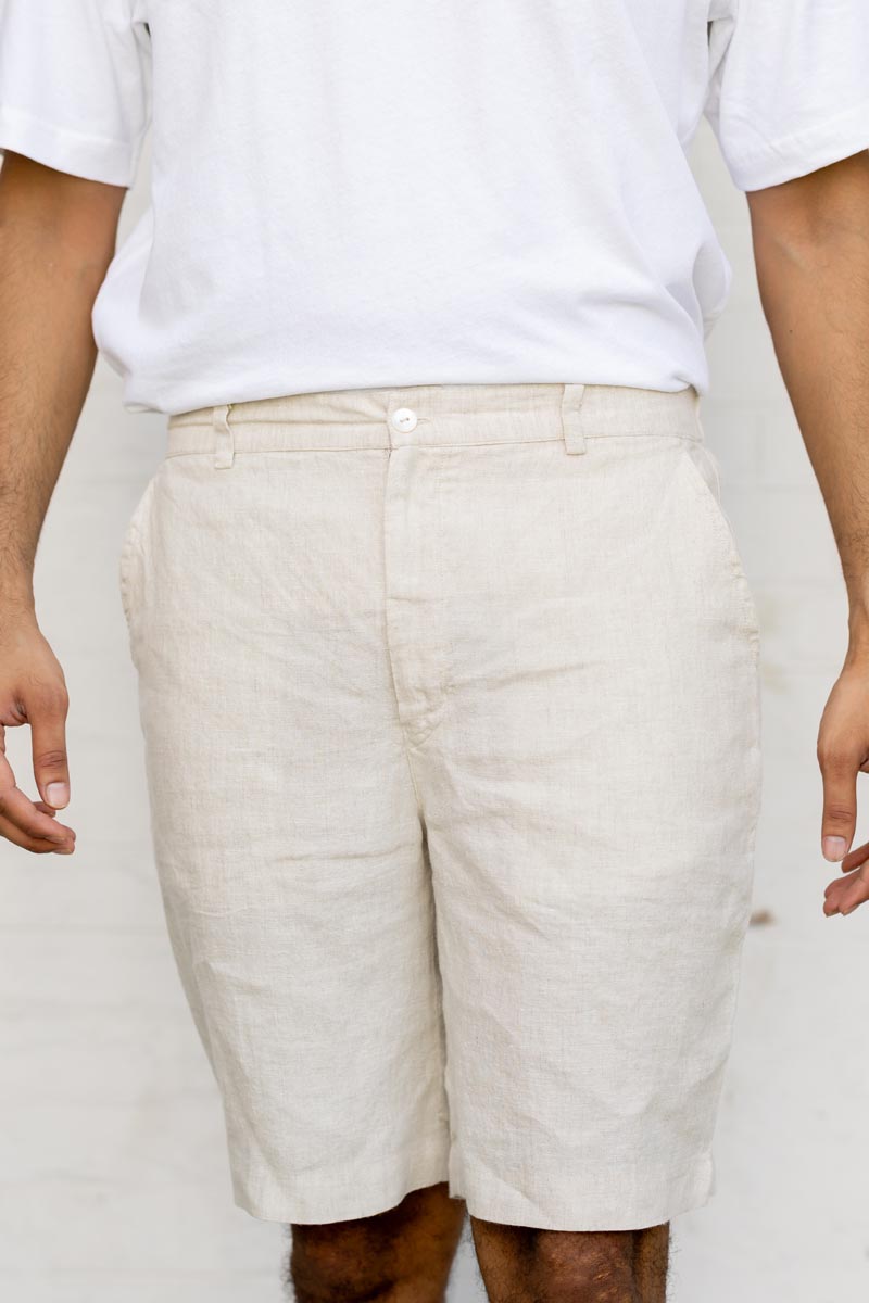 Person wearing Classic Cream Shorts and a white t-shirt against a plain background