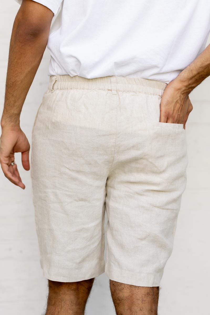 Person wearing Classic Cream Shorts and a white shirt against a plain background