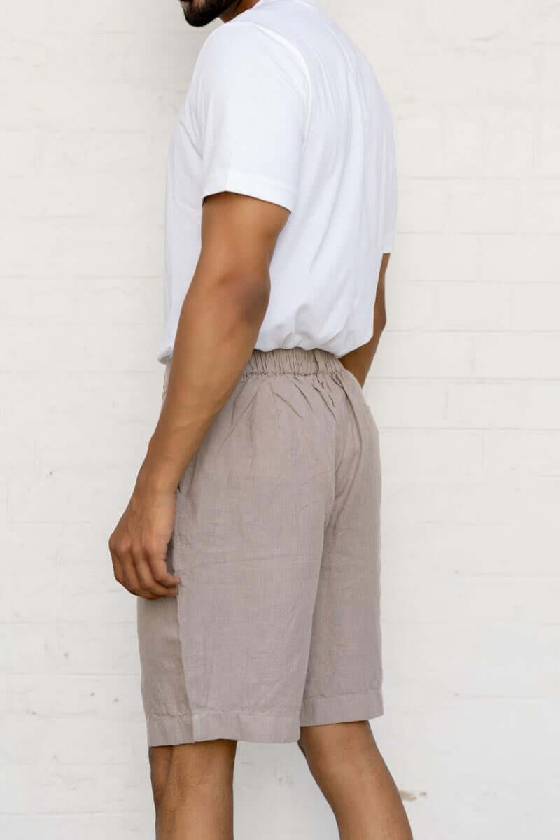 Person wearing a white t-shirt and Almond Beige Shorts against a white background