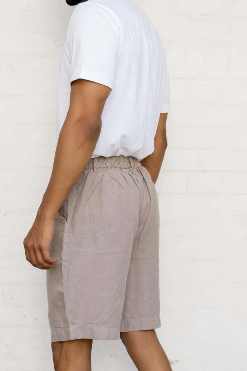 Person wearing a white t-shirt and Almond Beige Shorts against a plain background