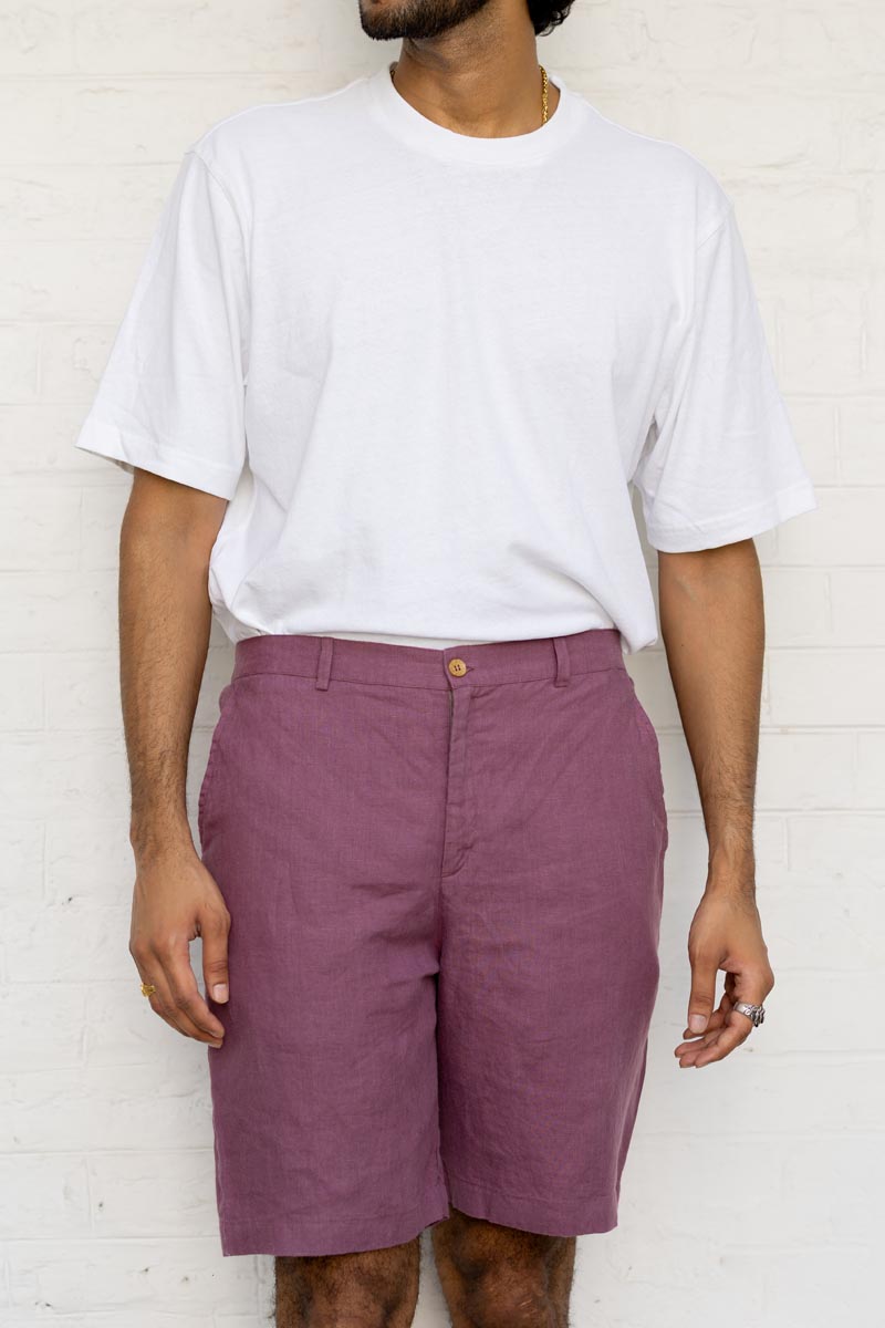 Person wearing a white t-shirt and Twilight Purple Shorts against a white background