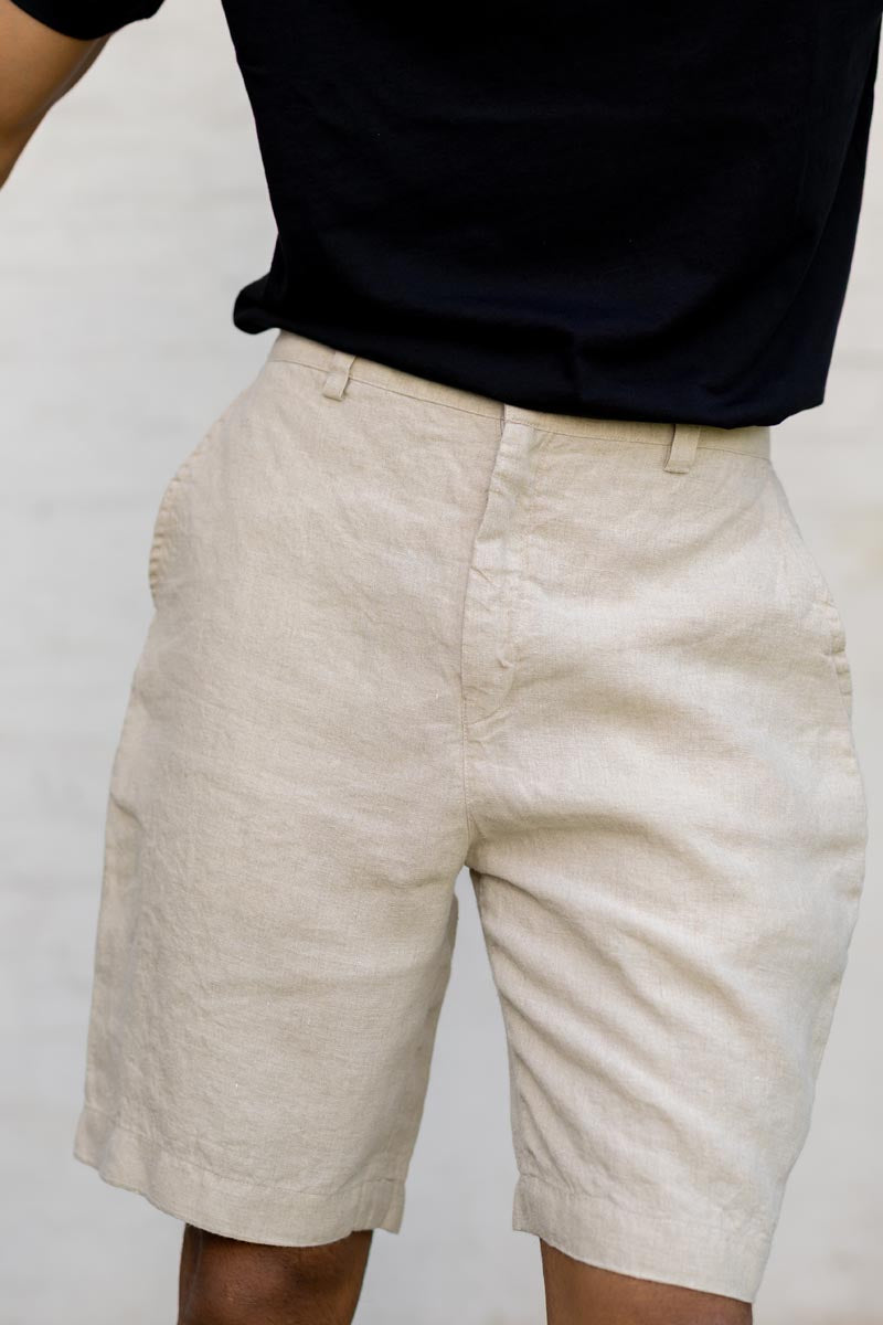 Person wearing Macadamia Shorts and a black shirt against a plain background