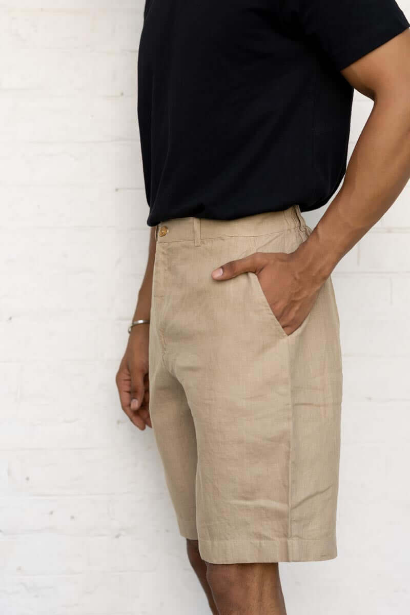 Person wearing Desert Sand Shorts and a black shirt against a white background