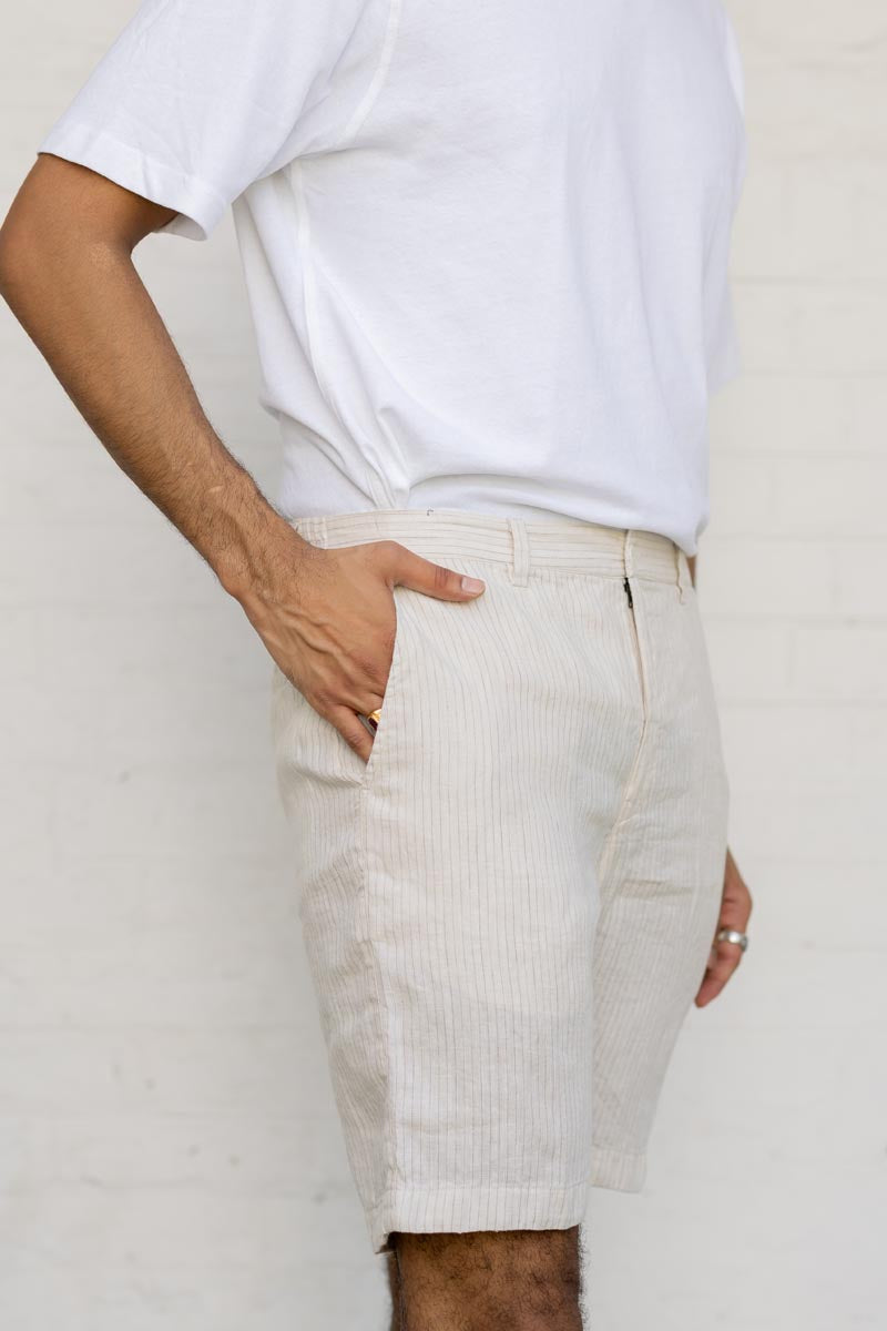 Person wearing a white t-shirt and Beige Hairline Stripe Shorts against a plain background