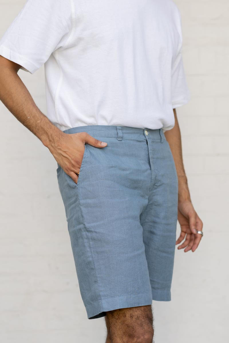 Person wearing Airforce Blue Shorts and a white shirt against a plain background