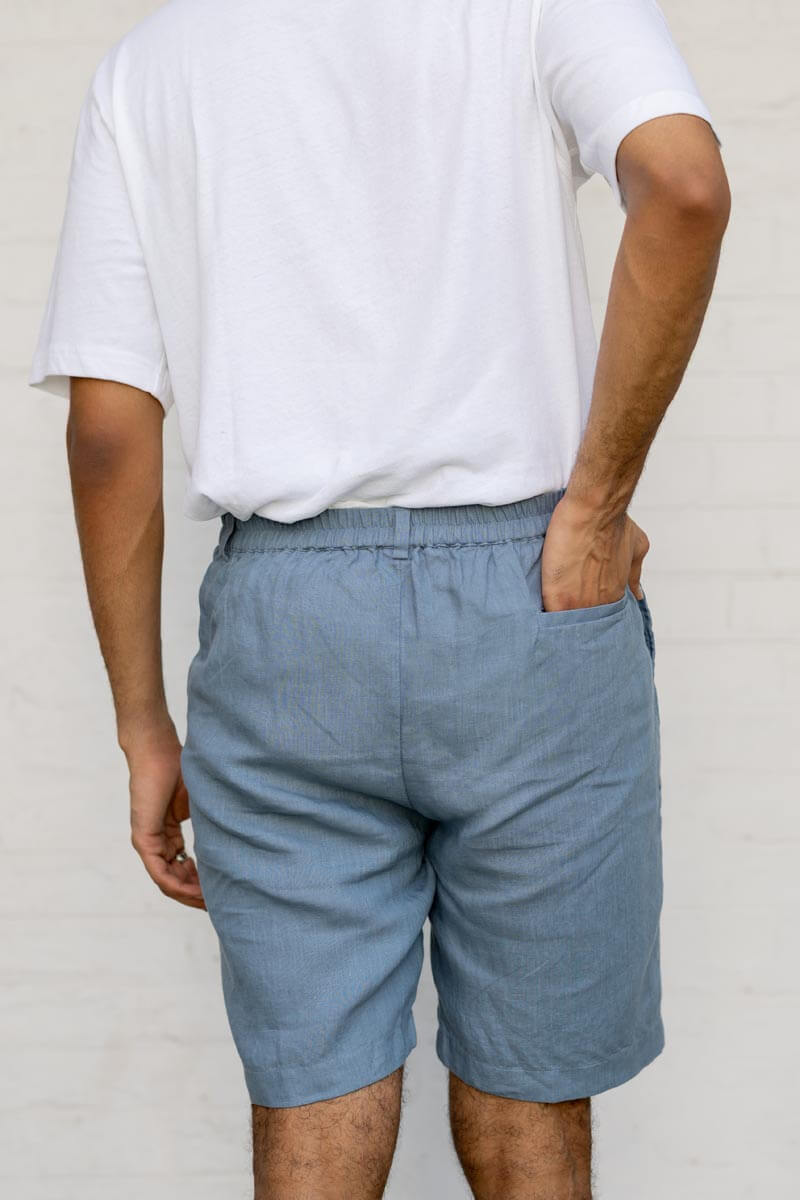 Person wearing Airforce Blue Shorts and a white t-shirt against a plain background