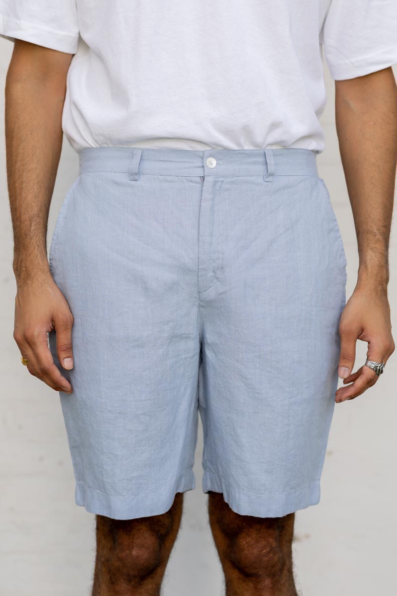 Person wearing Pacific Blue Shorts and a white shirt against a plain background