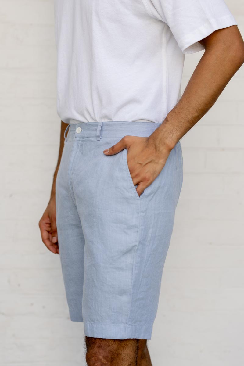 Person wearing Pacific Blue Shorts and a white shirt against a plain background