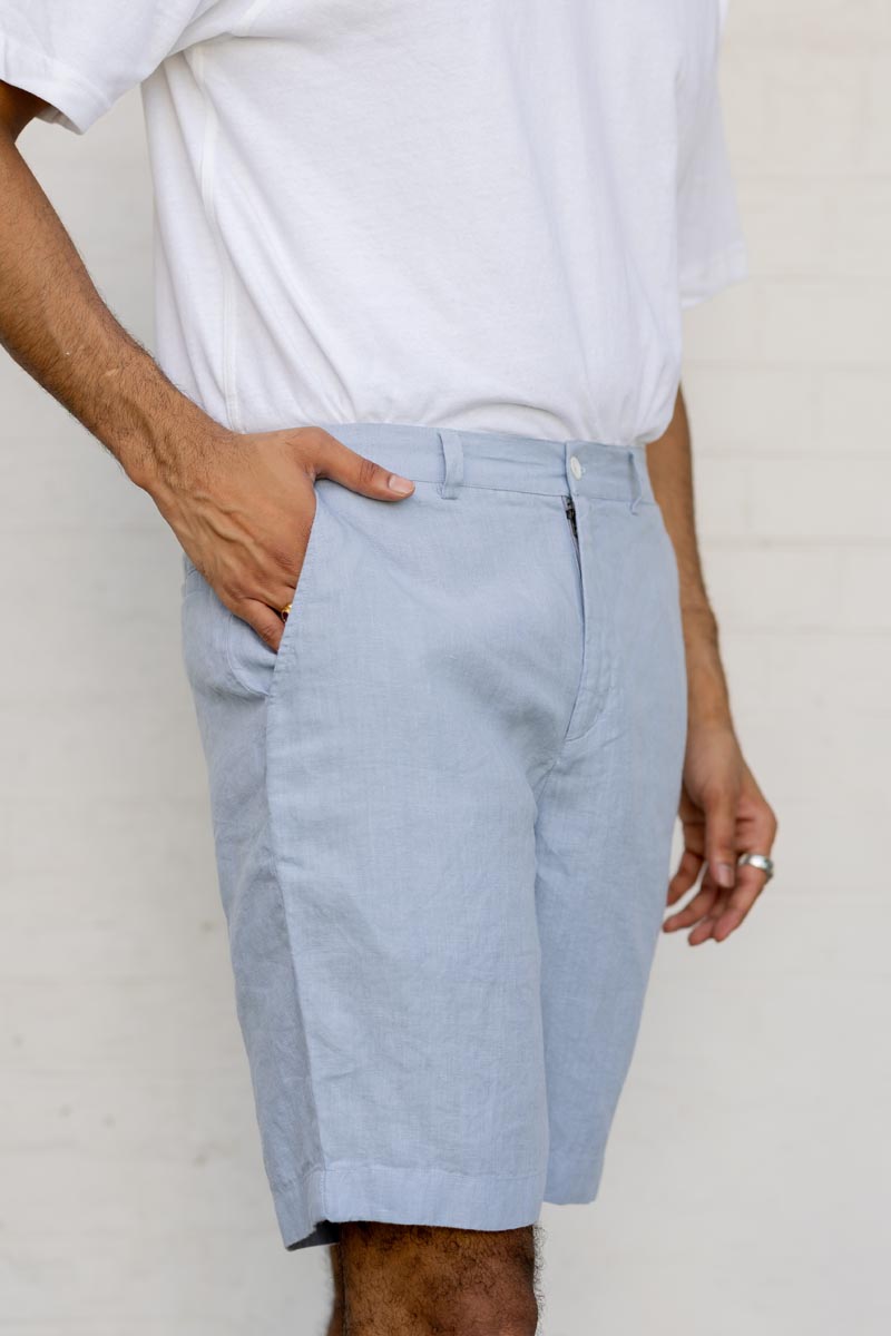 Person wearing Pacific Blue Shorts and a white shirt against a plain background