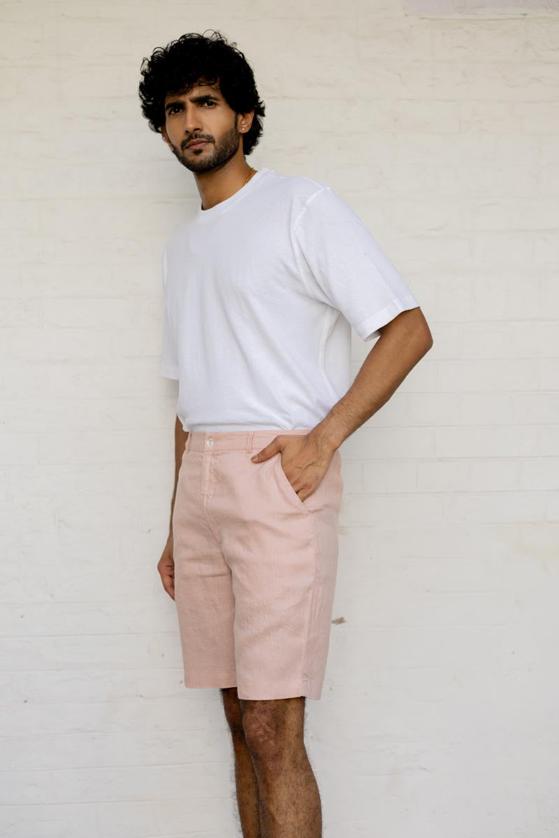 Man wearing a white t-shirt and Flamingo Shorts against a plain background