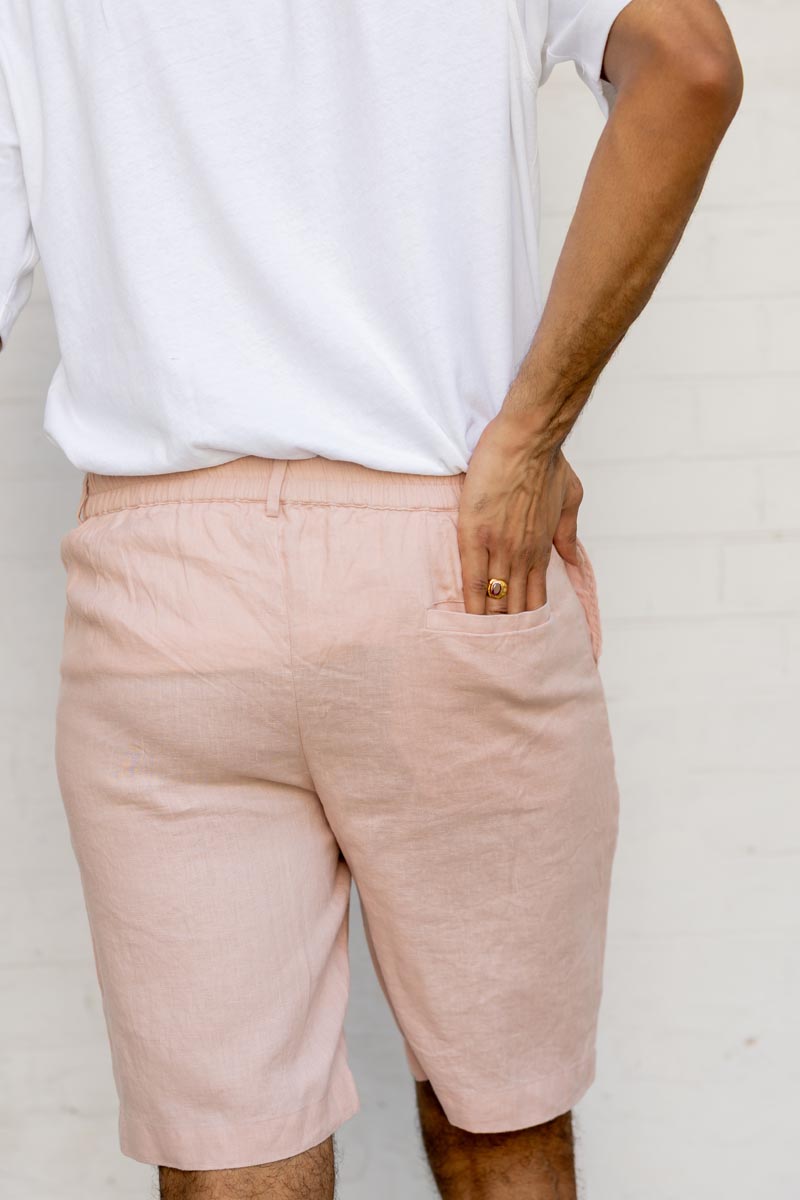 Person wearing Flamingo Shorts and a white top against a plain background