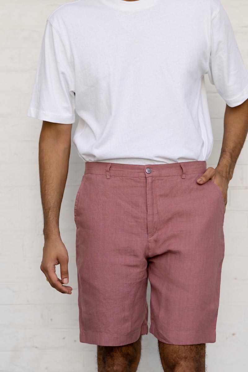 Person wearing a white t-shirt and Rose Gold Shorts against a plain background