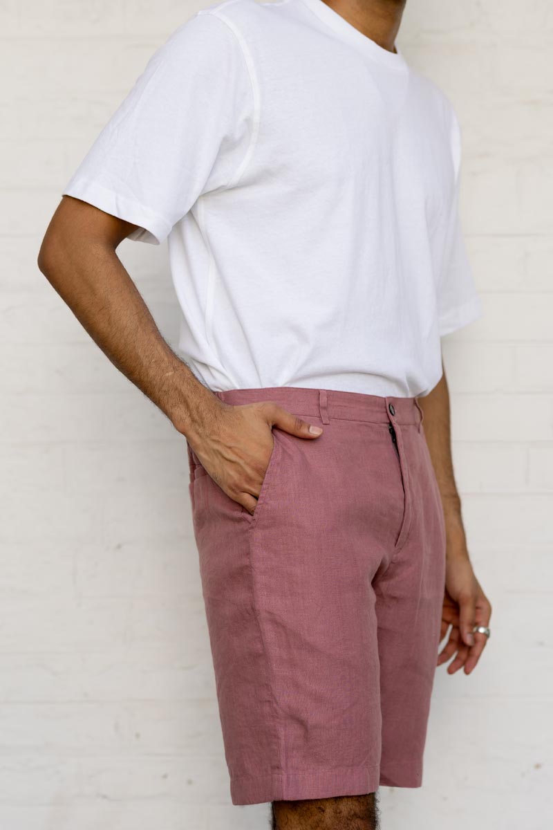 Person wearing a white t-shirt and Rose Gold Shorts against a white background