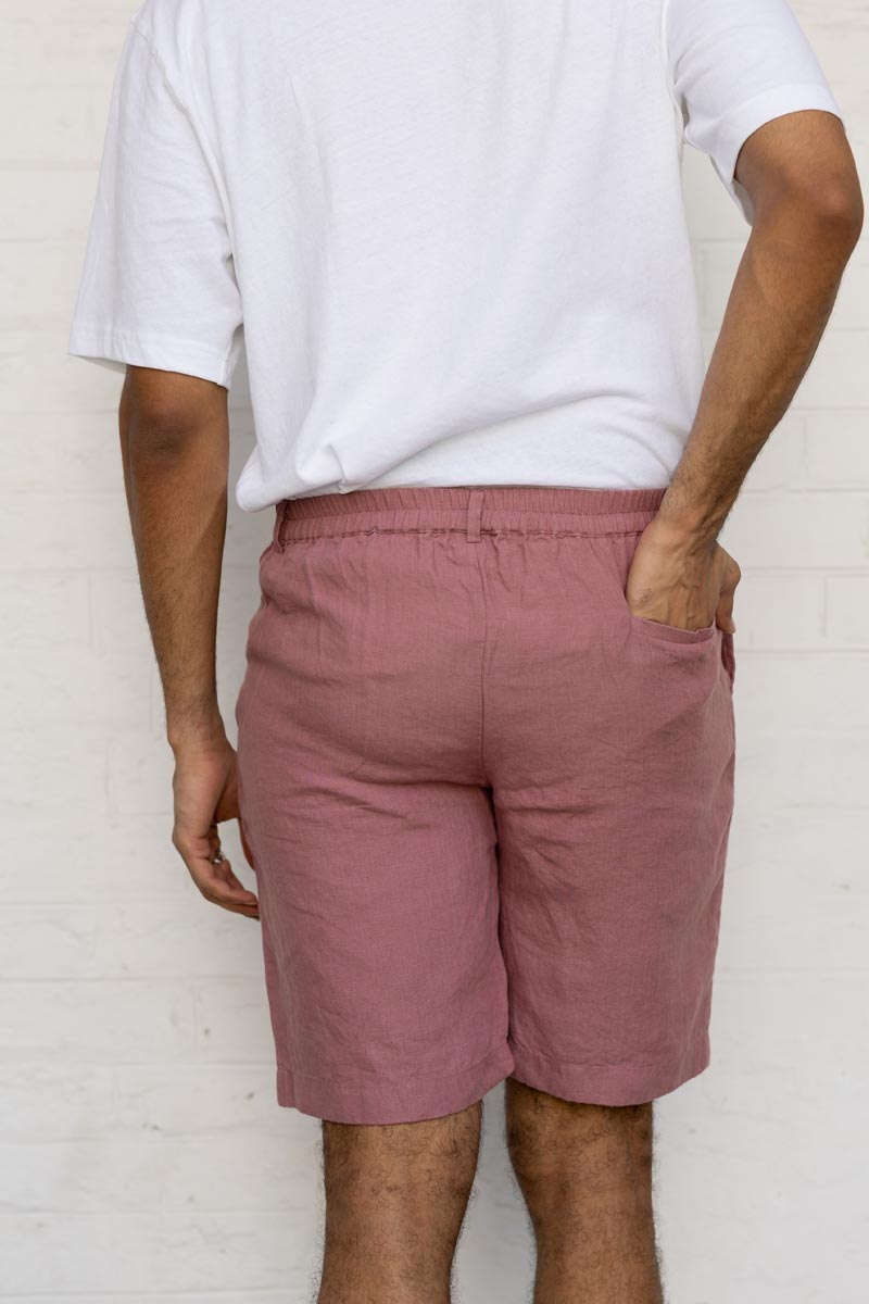 Person wearing Rose Gold Shorts and a white shirt against a white background