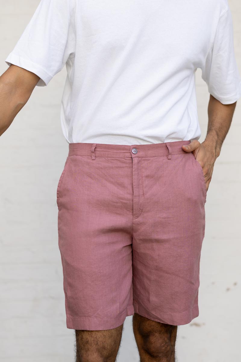 Person wearing Rose Gold Shorts and a white t-shirt against a plain background