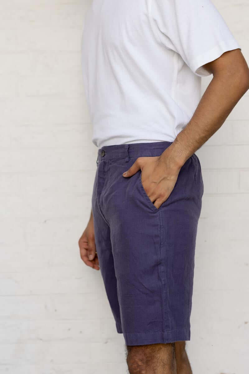 Person wearing Blueberry Shorts and a white shirt against a white wall